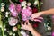 Florist at work. Woman making spring floral decorations the wedding table , the bride and groom.