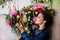 Florist at work. Woman making spring floral decorations the wedding table , the bride and groom. Flowers, candles, a bottle of ch