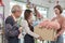 The florist workers deliver fresh floras to customer in colorful flower shop.