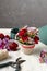 Florist workplace: Floral arrangement with red carnations and hypericum seeds