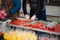 Florist wraps bouquets of fresh tulips in transparent packaging at the flower marke