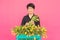 Floristics, holidays and people concept - Middle-aged woman holding box of tulips on a pink background