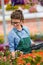 Florists woman working with flowers in a greenhouse