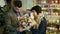 Florists and young attractive man are creating a bouquet of irises.