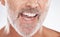 Floss, dental and face of senior man in studio isolated on a gray background. Cleaning, hygiene and elderly male model