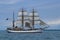 A flotilla of historic tall ships, sailing on Lake Erie in the summer.