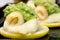 Flounder with asparagus puree ans sicilian lemon in a black plate close