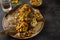 flounder baked with vegetables on a black background