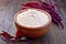 Flour amaranth in clay bowl with flower on dark board