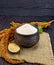 Flour amaranth in clay cup with flower on dark board