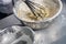 Flour and bread batter inside steel bowl on stainless