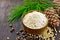 Flour cedar in wooden bowl with nuts on board