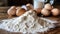 Flour, eggs and milk on a wooden table. Baking background