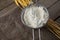 Flour inside sieve placed over wheat stem