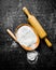 Flour with a ladle and rolling pin
