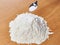 Flour with salt and spoon on table