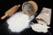 Flour sieved for homemade pastries. Accessories in home kitchen on a dark table