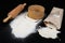 Flour sieved for homemade pastries. Accessories in home kitchen on a dark table