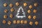Flour Silhouette Christmas Tree with cookies digits 2020 on dark background with copyspace. Delicious bakery sweet confectionery