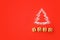 Flour Silhouette Christmas Tree with cookies digits 2020 on red background. Delicious bakery sweet confectionery Christmas card.