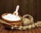 Flour in wooden bowl and wheat in burlap bag.