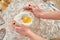 Flour, yolk and white flat lay on wooden pastry board.