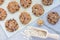 Flourless gluten free peanut butter, oatmeal and chocolate chips cookies on a parchment, top view, horizontal