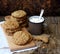 Flourless gluten free peanut butter, oatmeal, dried fruits cookies and cup of cocoa with marshmallows on brown background.