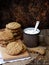 Flourless gluten free peanut butter, oatmeal, dried fruits cookies and cup of cocoa with marshmallows on wooden background. Vertic