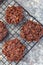 Flourless no bake peanut butter and oatmeal chocolate cookies on a cooling rack, vertical, top view