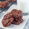 Flourless no bake peanut butter and oatmeal chocolate cookies  with glass of milk, square format