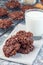 Flourless no bake peanut butter and oatmeal chocolate cookies with glass of milk, vertical