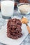 Flourless no bake peanut butter and oatmeal chocolate cookies with glass of milk, vertical