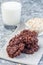 Flourless no bake peanut butter and oatmeal chocolate cookies, with glass of milk, vertical