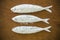 Floury fish on a wooden background