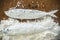 Floury fish on a wooden background