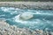 flow of water and spray from a stone close up