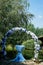 Flower arch for outdoor registration in nature with white and blue hydrangeas. With a table for Kolya, decorated with