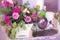 Flower arrangement in a basket decorate the wedding table in purple tones. Vintage.
