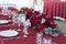 Flower arrangement in Burgundy colors is on the table in the restaurant