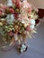 Flower arrangement cotton blooms in white, roses in a beautiful blend of peach, light peach and white color, preserved