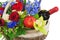 Flower arrangement of roses, orchids, fruits and bottle of wine