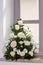 A flower bouquet of cream roses and chrysanthemums on the windows in the church as a decoration of the holiday. Professional flori