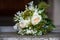 Flower bouquet and wedding rings on church stairs