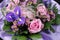 A flower bunch with pink roses and violet iris