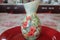 Flower colored vase. Red flowers