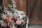 Flower composition with white and pink roses and other flowers on a rustic table. Artwork. Indoors.