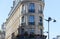 The flower-decked facade of raditional French house with typical balconies and windows. Paris.