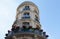 The flower-decked facade of raditional French house with typical balconies and windows. Paris.