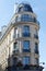 The flower-decked facade of traditional French house with typical balconies and windows. Paris.